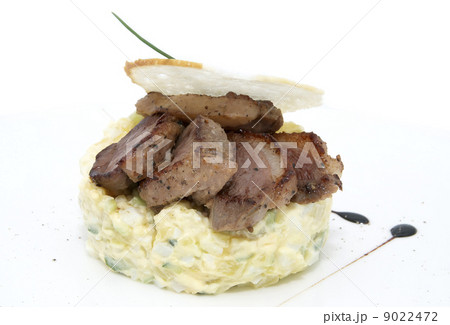 Olivier salad with meat on a white background in restaurant 9022472