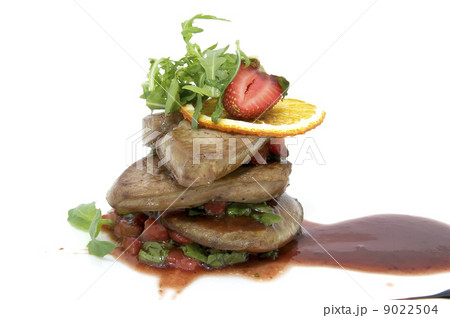 Roast goose liver is decorated with greens and strawberries Roast goose liver is decorated with greens and strawberries 9022504