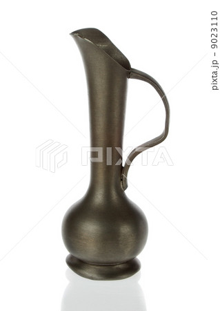 Antique brass pitcher, jug  on a white background. 9023110