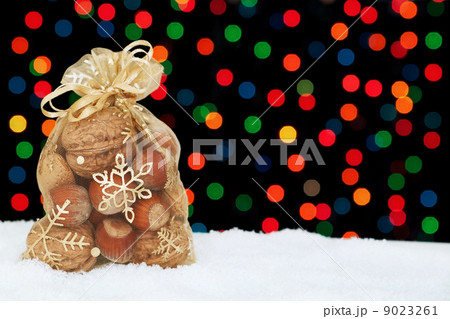 Christmas present in the snow on a background of colored bokeh. 9023261