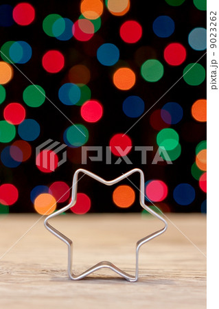 Star shape for baking Christmas cookies on a background bokeh. Star shape for baking Christmas cookies on a background bokeh. 9023262