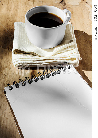Sketchbook and instant coffee in white cup against wood backgrou Sketchbook and instant coffee in white cup against wood backgrou 9024008