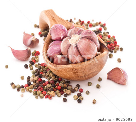 Garlic cloves in wooden bowl isolated on white background Garlic cloves in wooden bowl isolated on white background 9025698