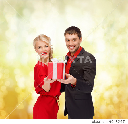 smiling woman and man with gift box smiling woman and man with gift box 9043267