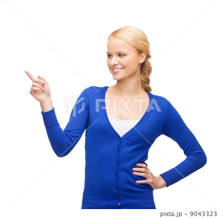 smiling woman in pointing her finger smiling woman in pointing her finger 9043323