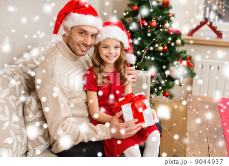 smiling father and daughter holding gift box 9044937