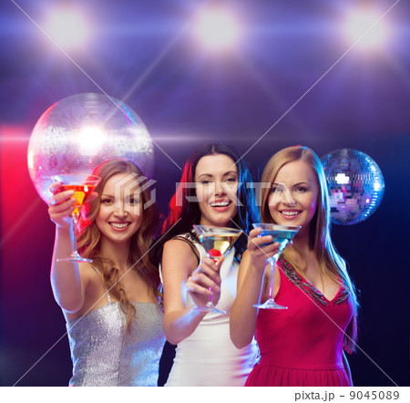three smiling women with cocktails and disco ball three smiling women with cocktails and disco ball 9045089