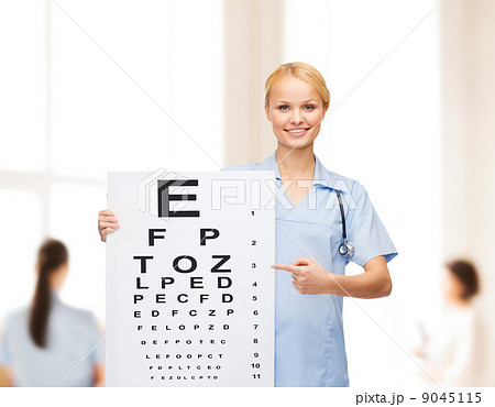 smiling female doctor or nurse with eye chart smiling female doctor or nurse with eye chart 9045115