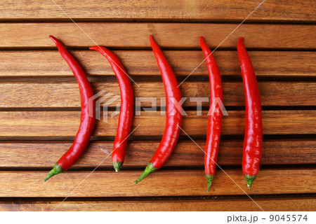red peppers on wooden table red peppers on wooden table 9045574