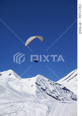 Paraglider in sunny snowy mountains 9051562
