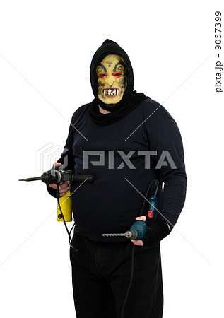 Maniac holds in hands one perforator and electric drill Maniac holds in hands one perforator and electric drill 9057399