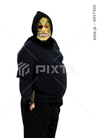Maniac in a mask threatens with a knife 9057400