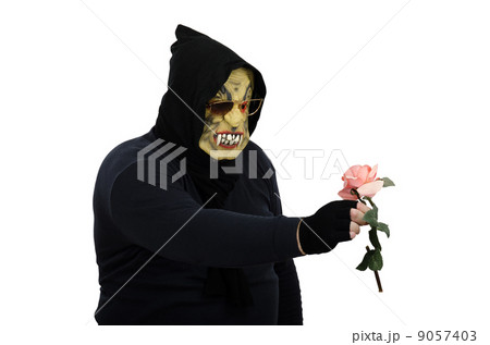 Glasses monster examines pink rose 9057403