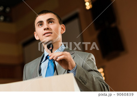 Portrait of a business man holding microphone 9060839