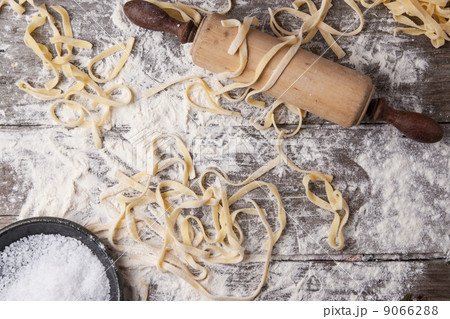 Raw homemade pasta with rolling pin 9066288