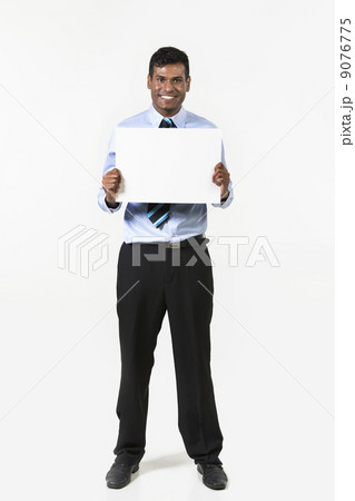 Indian man holding up a banner. 9076775
