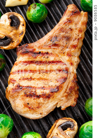 Grilled pork chop with brussels sprouts 9086585