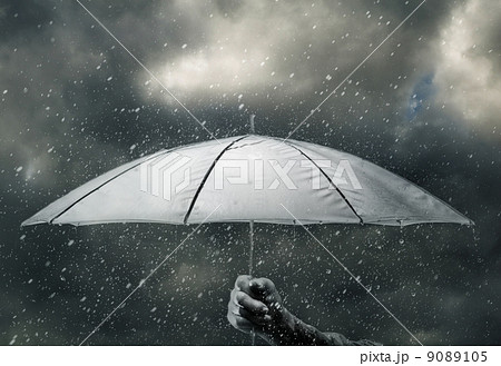 Umbrella in hand under raindrops 9089105