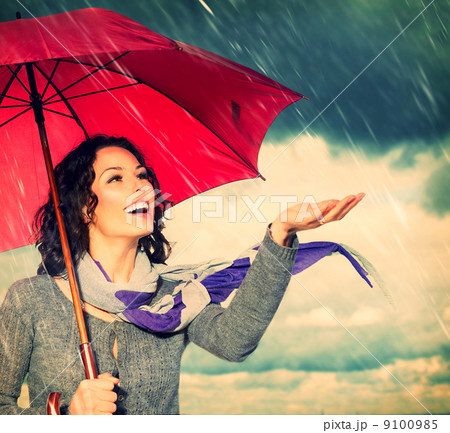 Smiling Woman with Umbrella over Autumn Rain Background 9100985