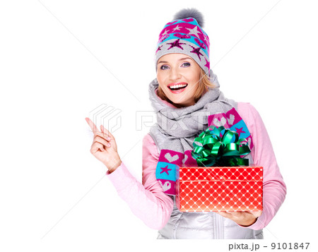 woman with a gift in a winter outerwear  pointing by finger 9101847
