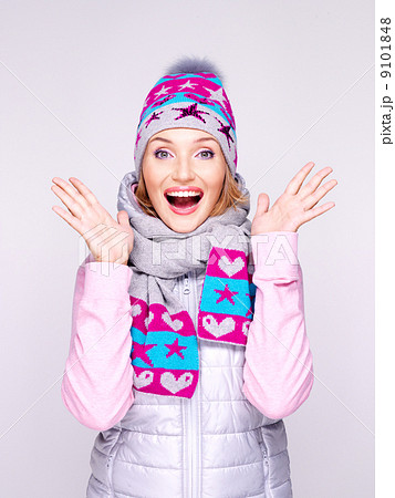 happy surprised woman in winter clothes with positive emotions 9101848