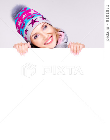 Happy woman in winter outerwear over white banner 9101851