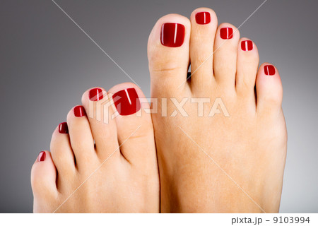 Beautiful female feet with red pedicure Beautiful female feet with red pedicure 9103994
