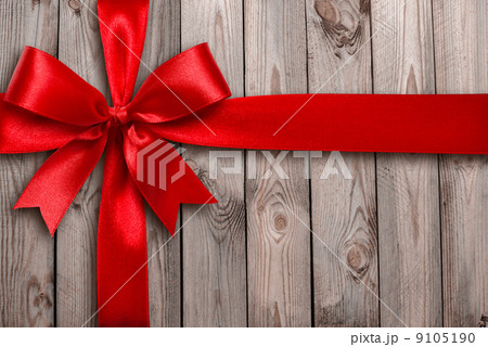 Red ribbon on a wooden background Red ribbon on a wooden background 9105190