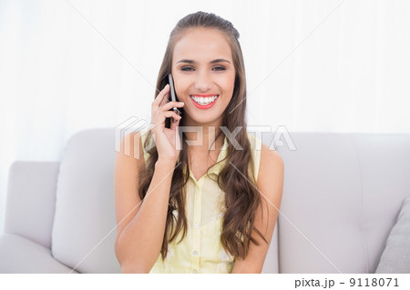 Cheerful pretty brunette using mobile phone 9118071