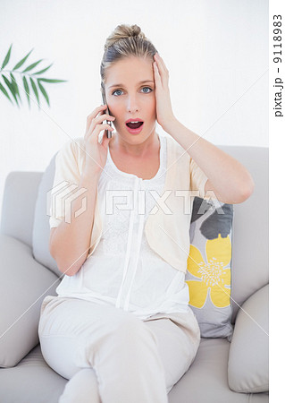 Shocked fresh blonde in white clothes on the phone Shocked fresh blonde in white clothes on the phone 9118983