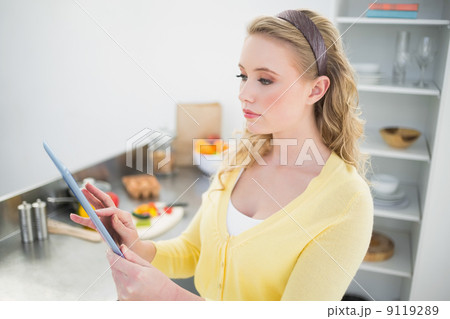 Content cute blonde using tablet Content cute blonde using tablet 9119289