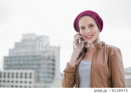 Cheerful casual blonde on the phone outdoors 9119473