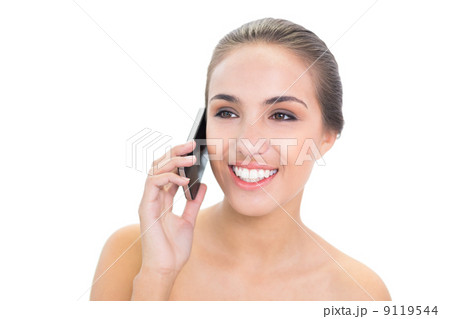 Cheerful young brunette woman using a mobile phone 9119544