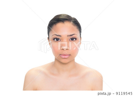Serious young dark haired model posing looking at camera 9119545
