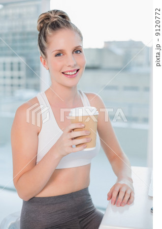 Happy athletic blonde holding coffee Happy athletic blonde holding coffee 9120772