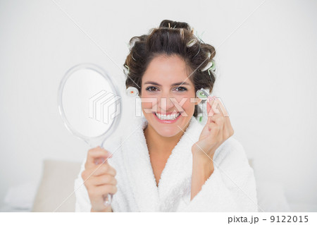 Cheerful natural brunette holding tweezers Cheerful natural brunette holding tweezers 9122015