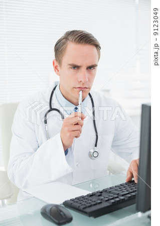 Male doctor using computer at medical office 9123049