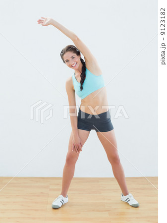 Full length portrait of a smiling woman stretching hand Full length portrait of a smiling woman stretching hand 9123182