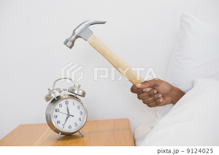 Smashing alarm clock with hammer Smashing alarm clock with hammer 9124025