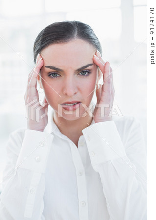 Elegant businesswoman suffering from headache 9124170