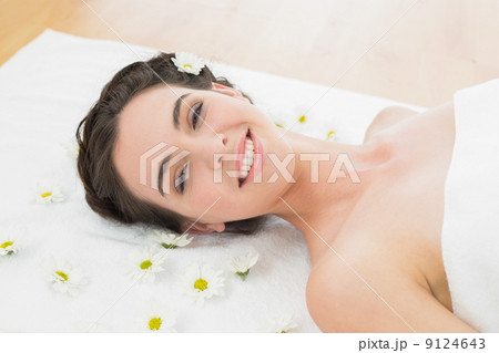 Beautiful young woman with flowers in beauty salon 9124643