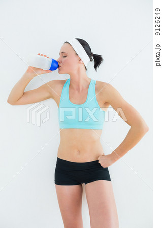 Sporty fit young woman drinking water Sporty fit young woman drinking water 9126249