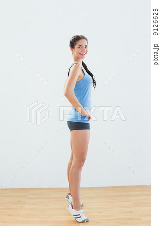 Side view of a sporty woman tip toeing 9126623