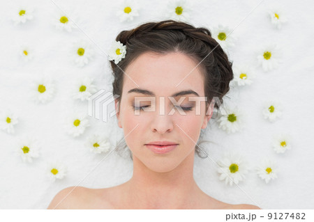 Beautiful woman with flowers in beauty salon 9127482