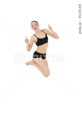 Euphoric slim model jumping in the air 9128169