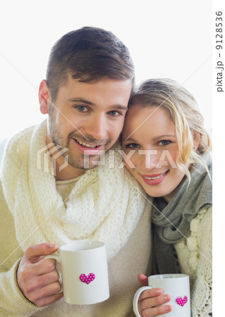 Loving couple in winter clothing with coffee cups Loving couple in winter clothing with coffee cups 9128536
