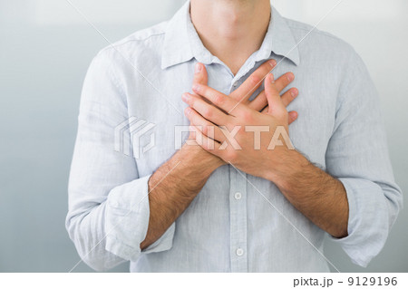Mid section of a man with chest pain Mid section of a man with chest pain 9129196