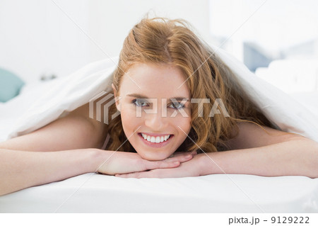 Close up portrait of a pretty woman in bed 9129222