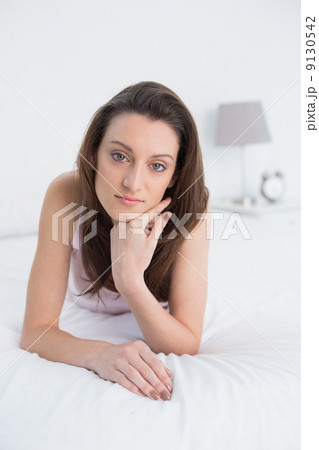 Close up portrait of a pretty woman resting in bed 9130542
