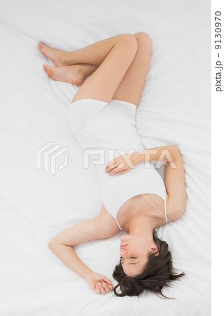 Beautiful young woman sleeping in bed 9130970